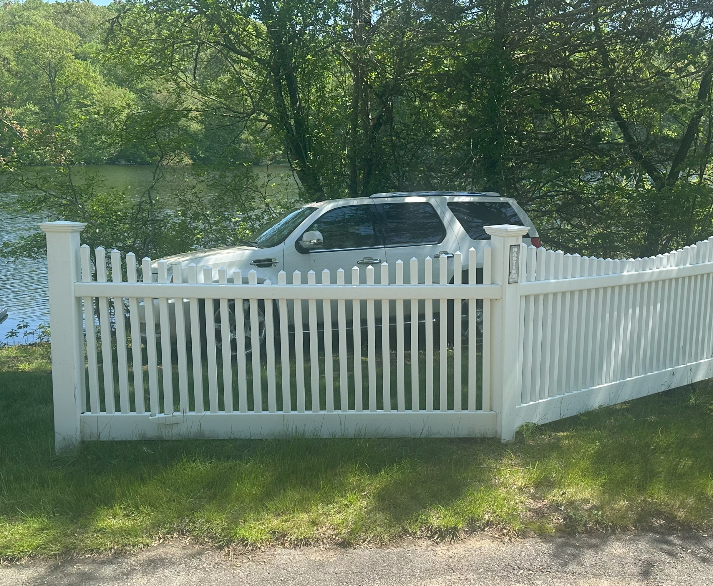 Second fence after professional pressure washing Voluntown CT - pristine white and clean